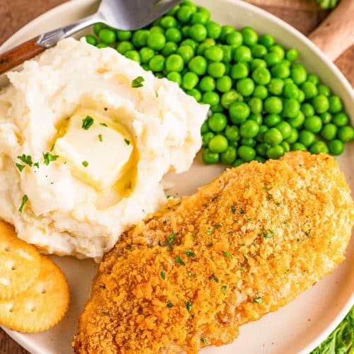 Close up overhead photo of a plate with ritz cracker chicken, peas, and mashed potato on it.