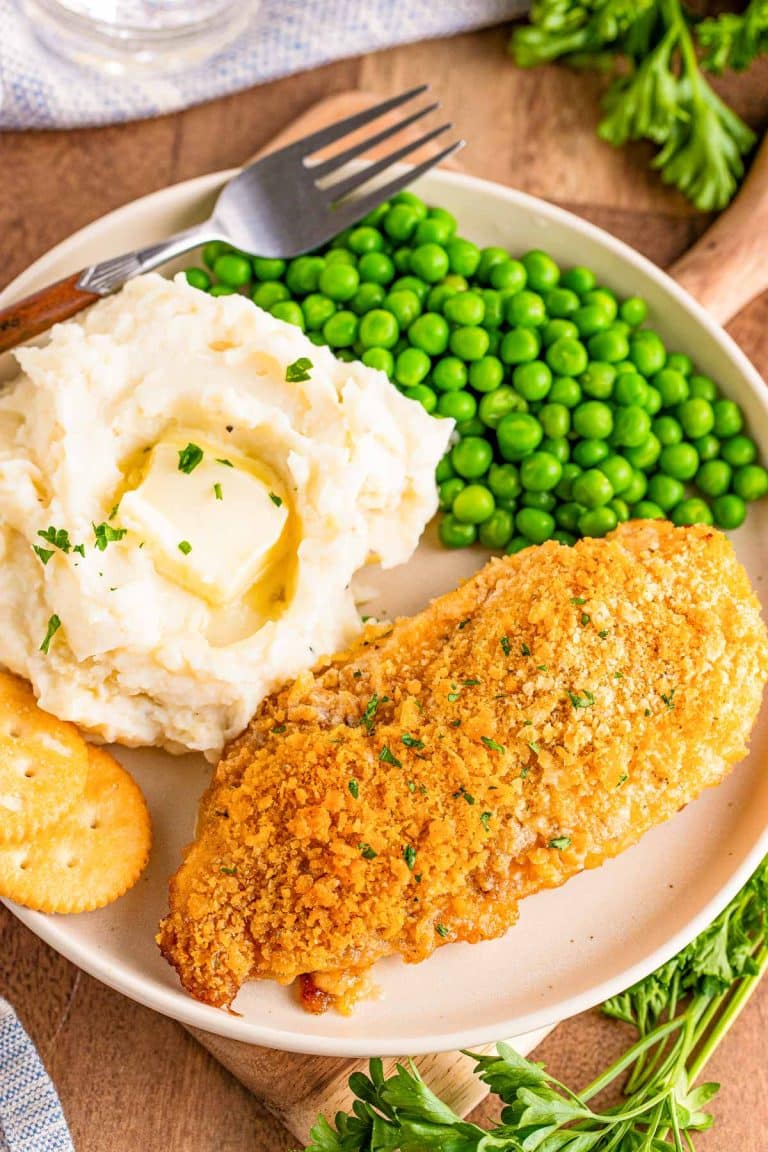Close up overhead photo of a plate with ritz cracker chicken, peas, and mashed potato on it.
