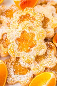 Pie crust cookies made with orange marmalade and shaped like flowers on a