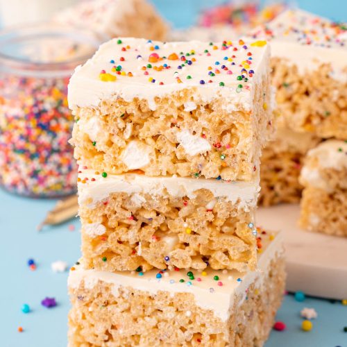Close up of a stack of three birthday cake rice krispie treats.