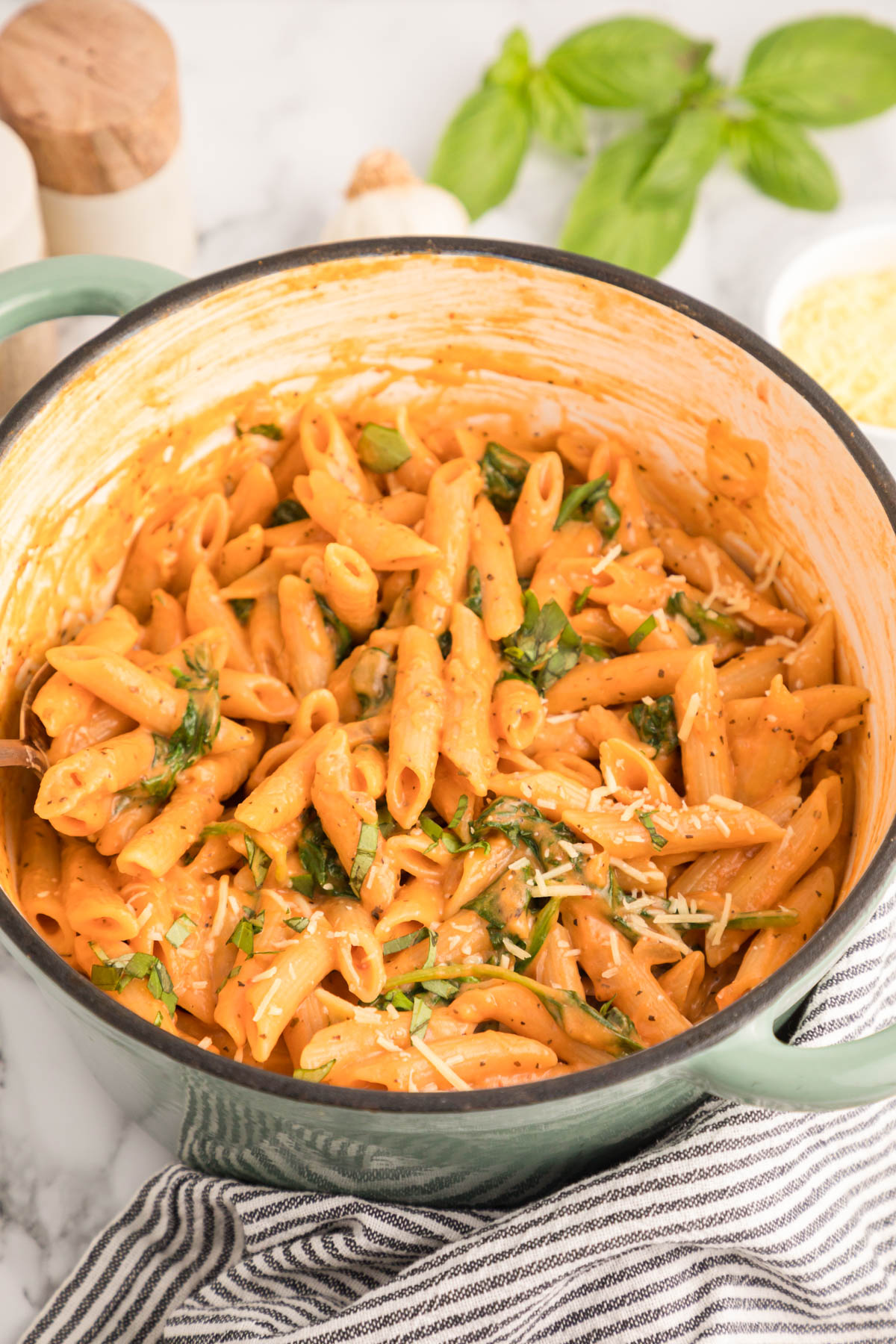 A dutch oven filled with creamy tomato pasta.
