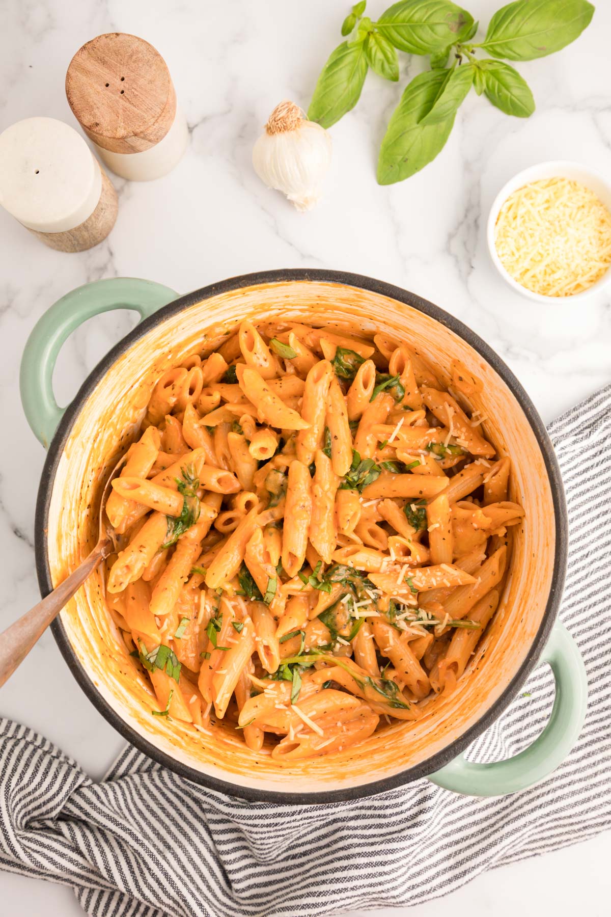 An overhead photo of a Dutch oven filled with one-pot creamy tomato pasta.