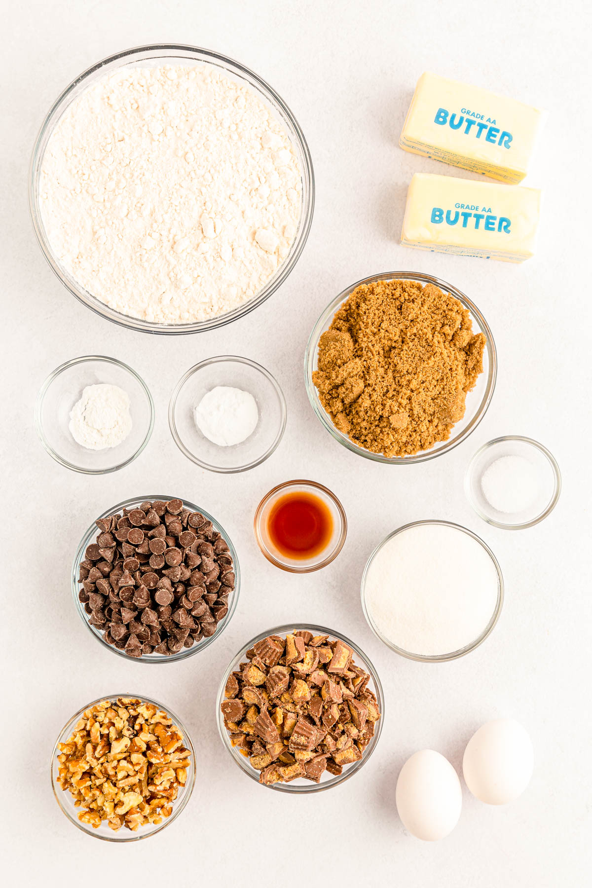 Overhead photo of ingredients prepped to make peanut butter cookie bars on a white table.