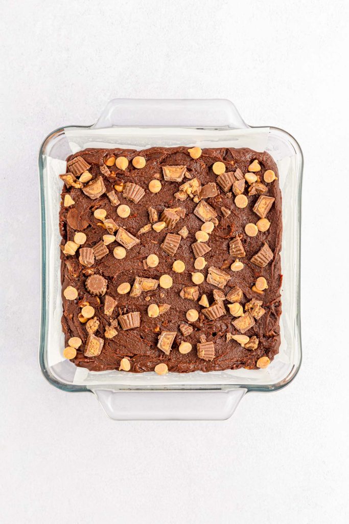 A square pan of peanut butter brownie batter.