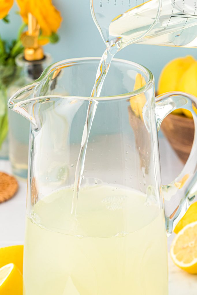 Lemonade being made in a pitcher.