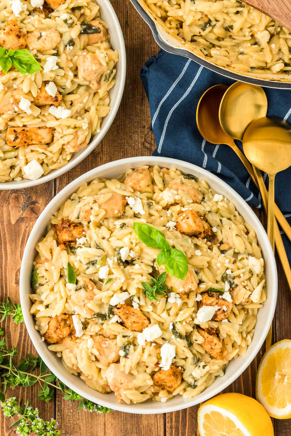 Lemon Chicken Orzo in a white bowl on a wooden table.