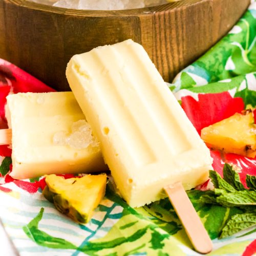 Dole whip popsicles on a colorful napkin.
