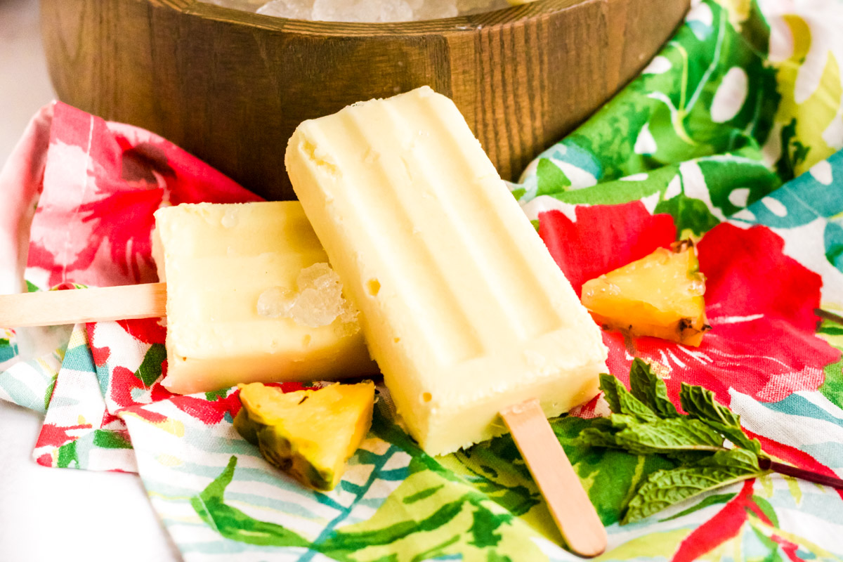 Dole whip popsicles on a colorful napkin.