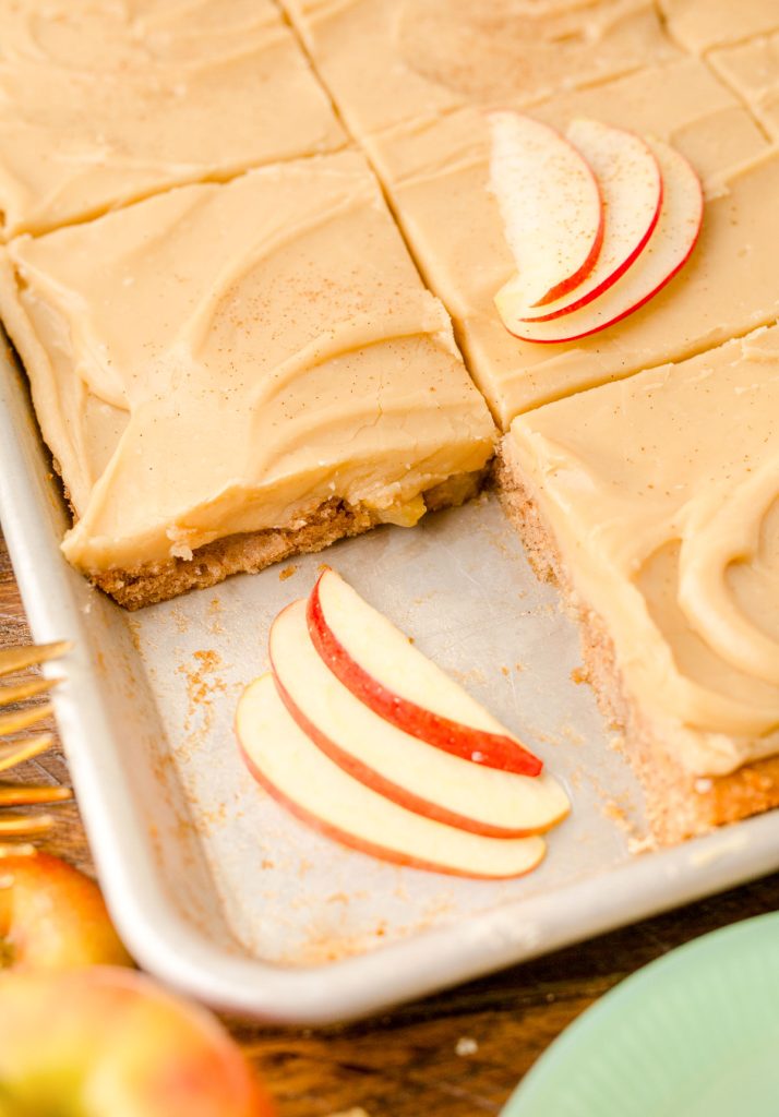 Caramel apple sheet cake with a slice missing.