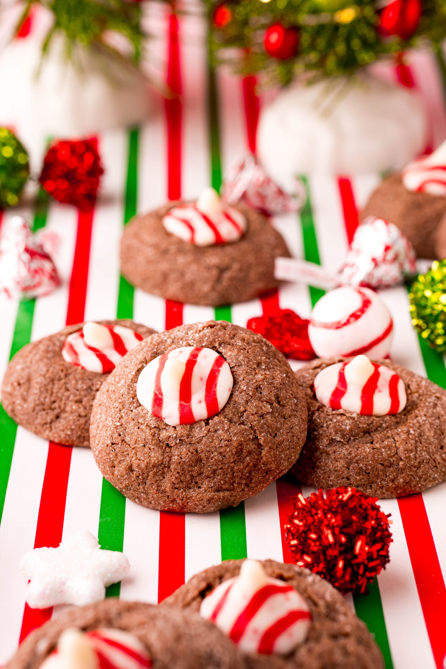 three peppermint thumbprint cookies on a table.